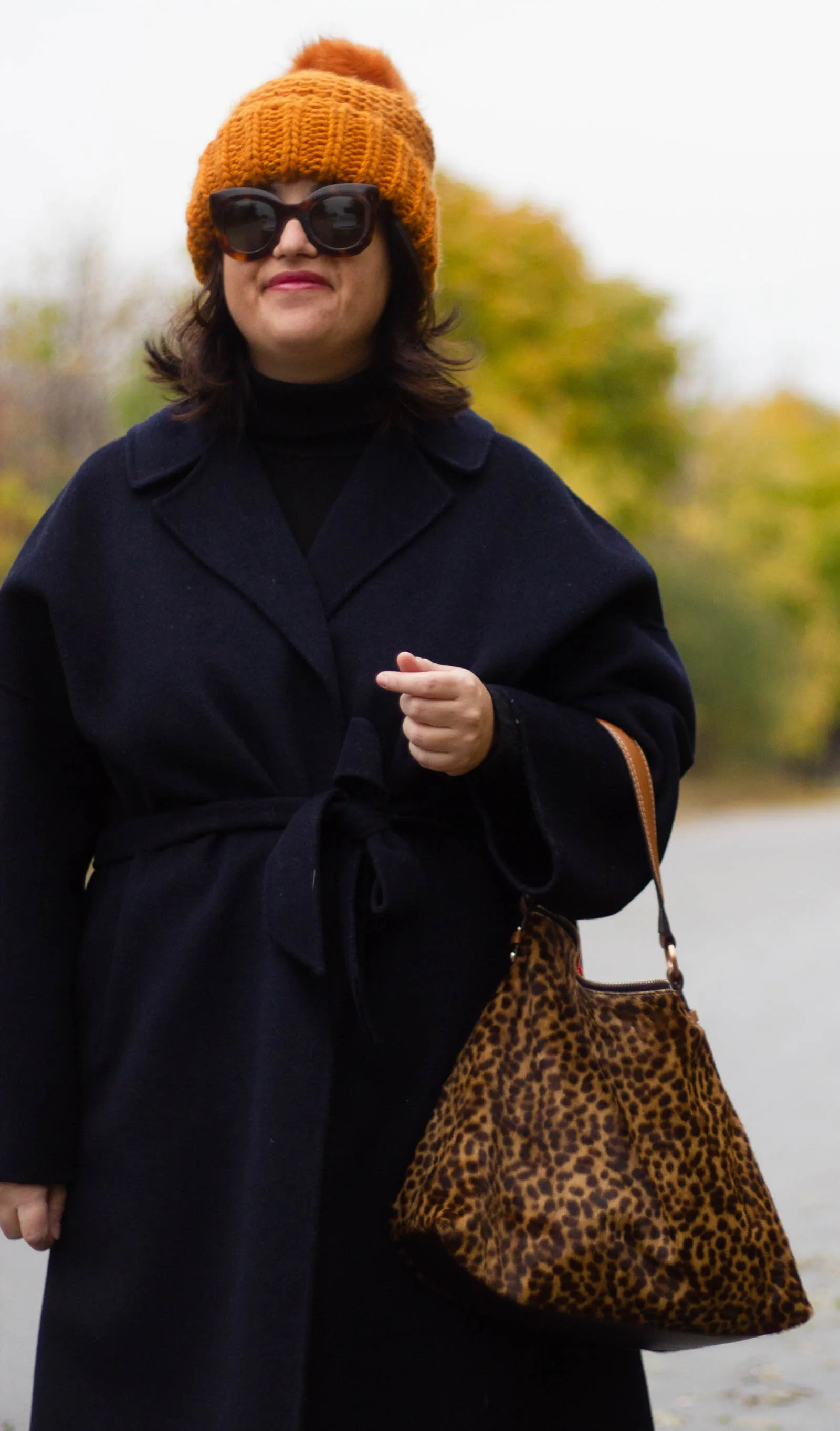 navy wrap coat, leopard bag and burnt orange hat