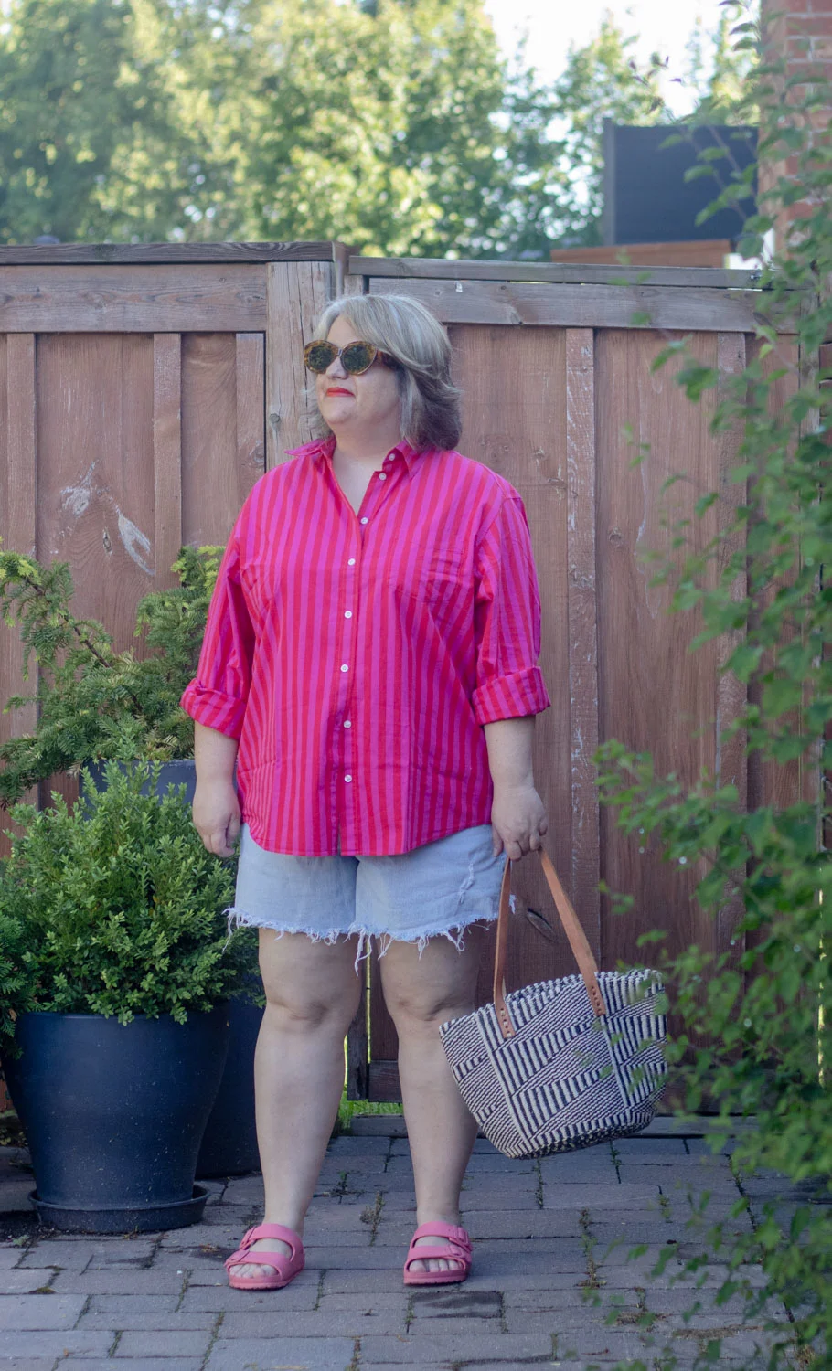 oversized striped button front shirt with cut off denim shorts. 