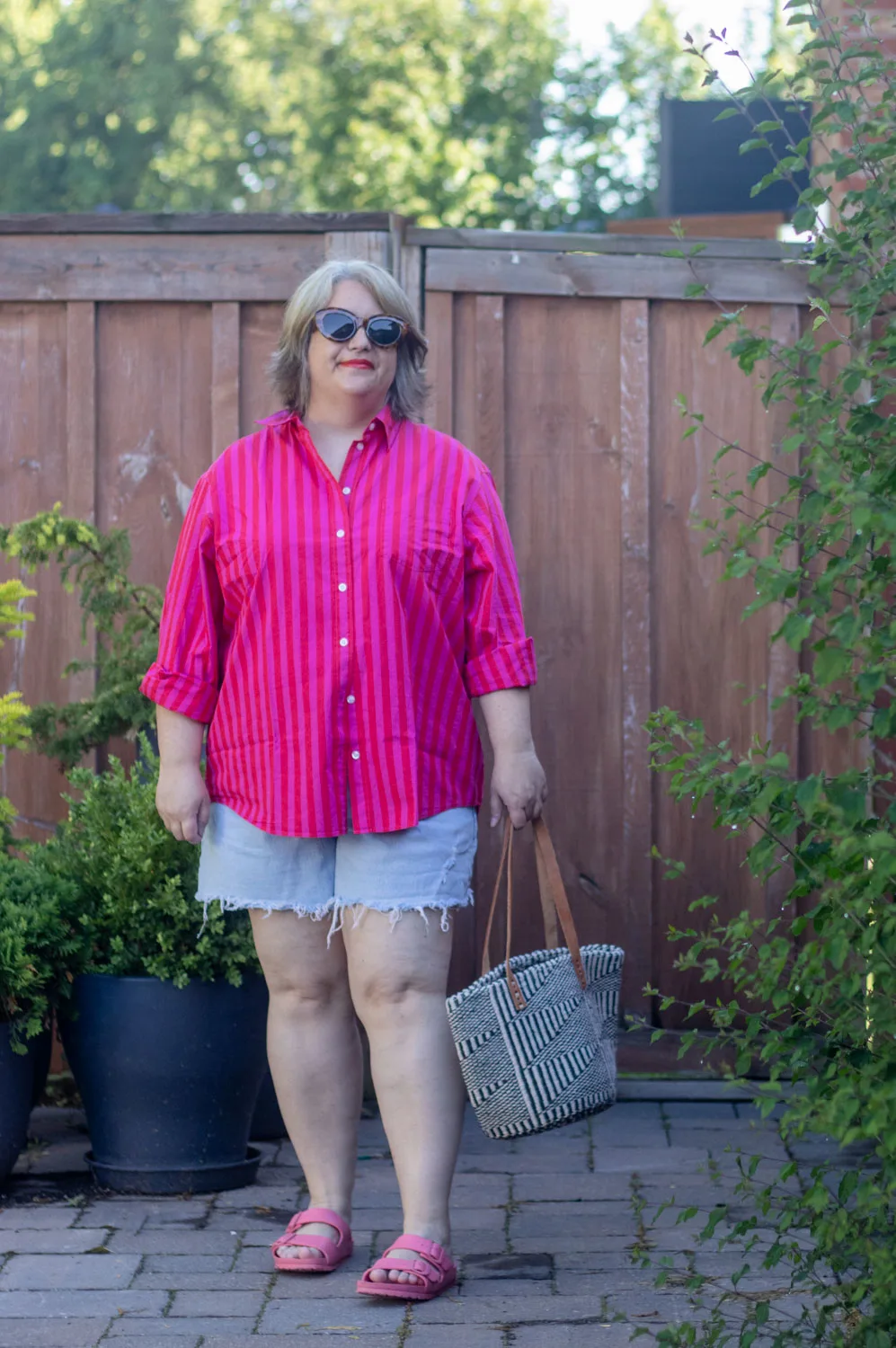 oversized striped button front shirt with cut off denim shorts. 