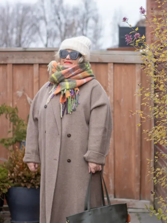 greige coat with soft hued accessories and green