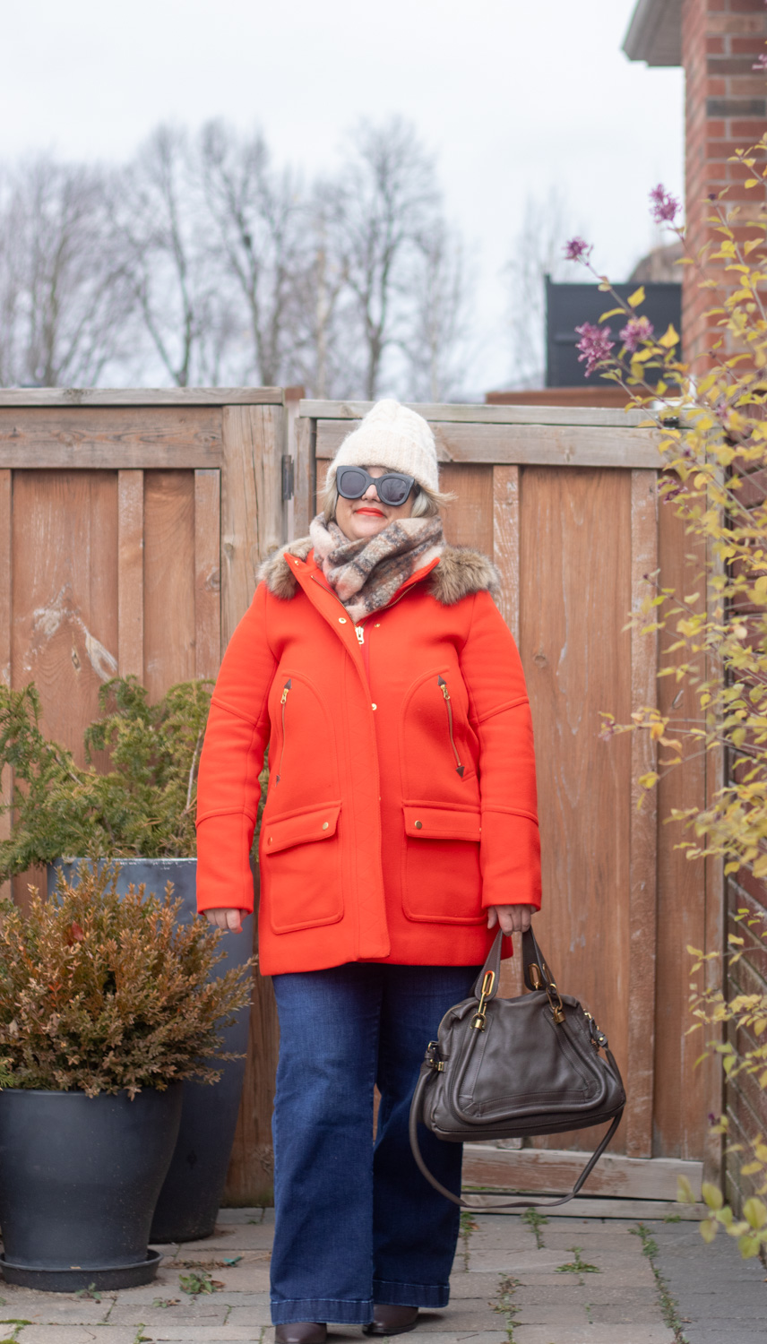 red coat with brown plaid scarf