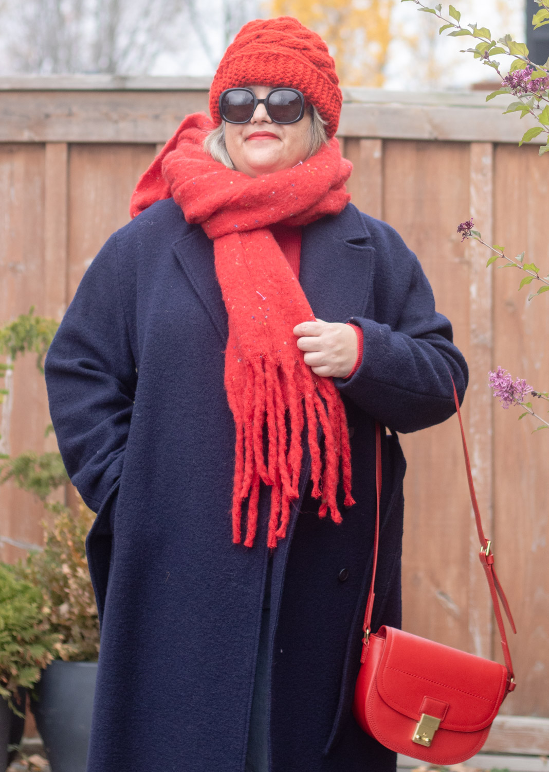 navy coat and red accessories outfit