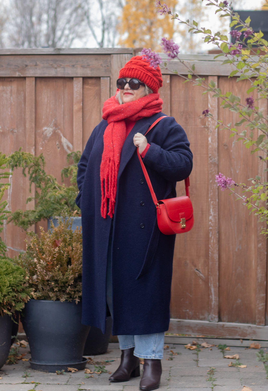 navy coat with red accessories