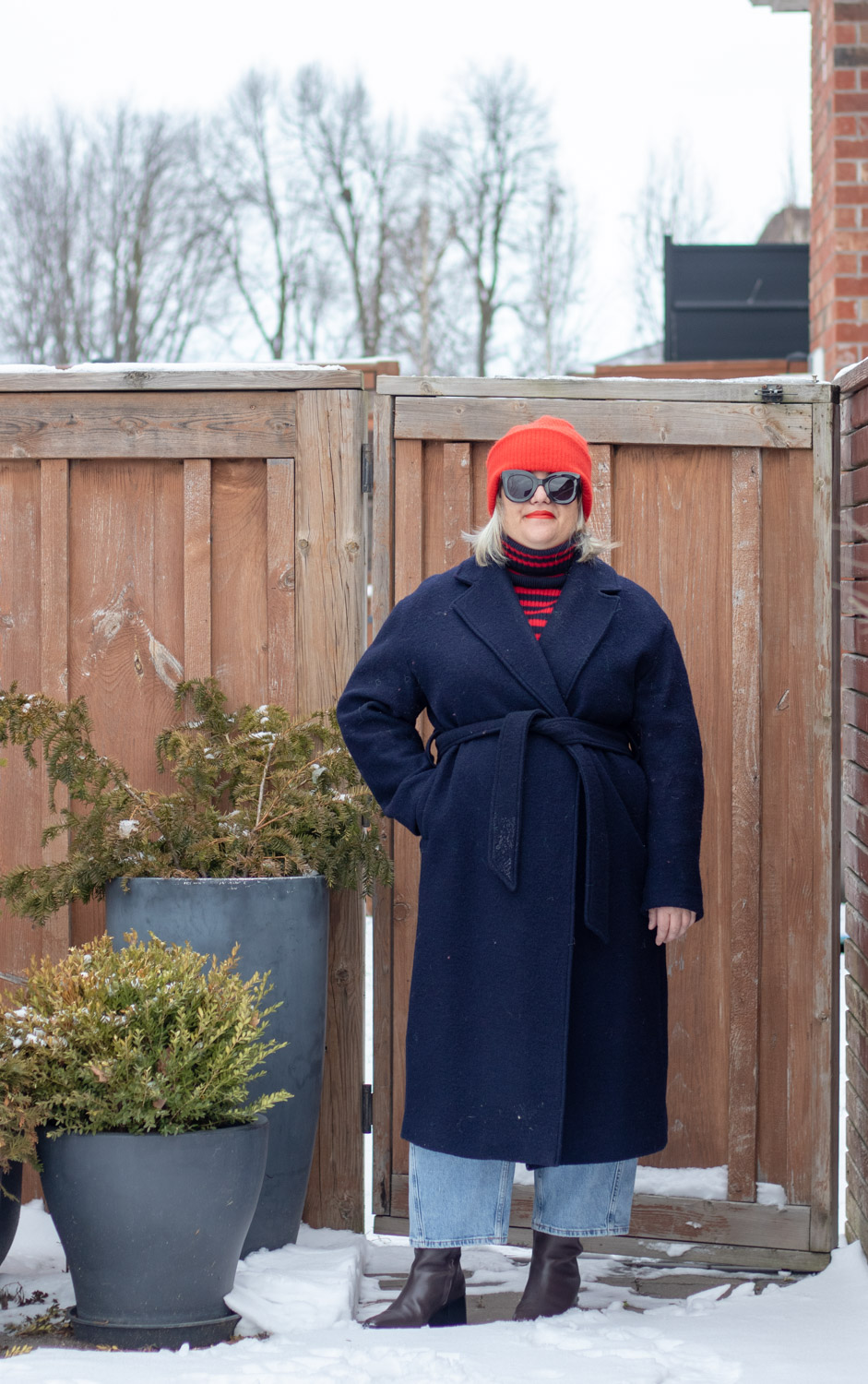 Navy belted coat, red and navy stripe turtleneck red hat outfit