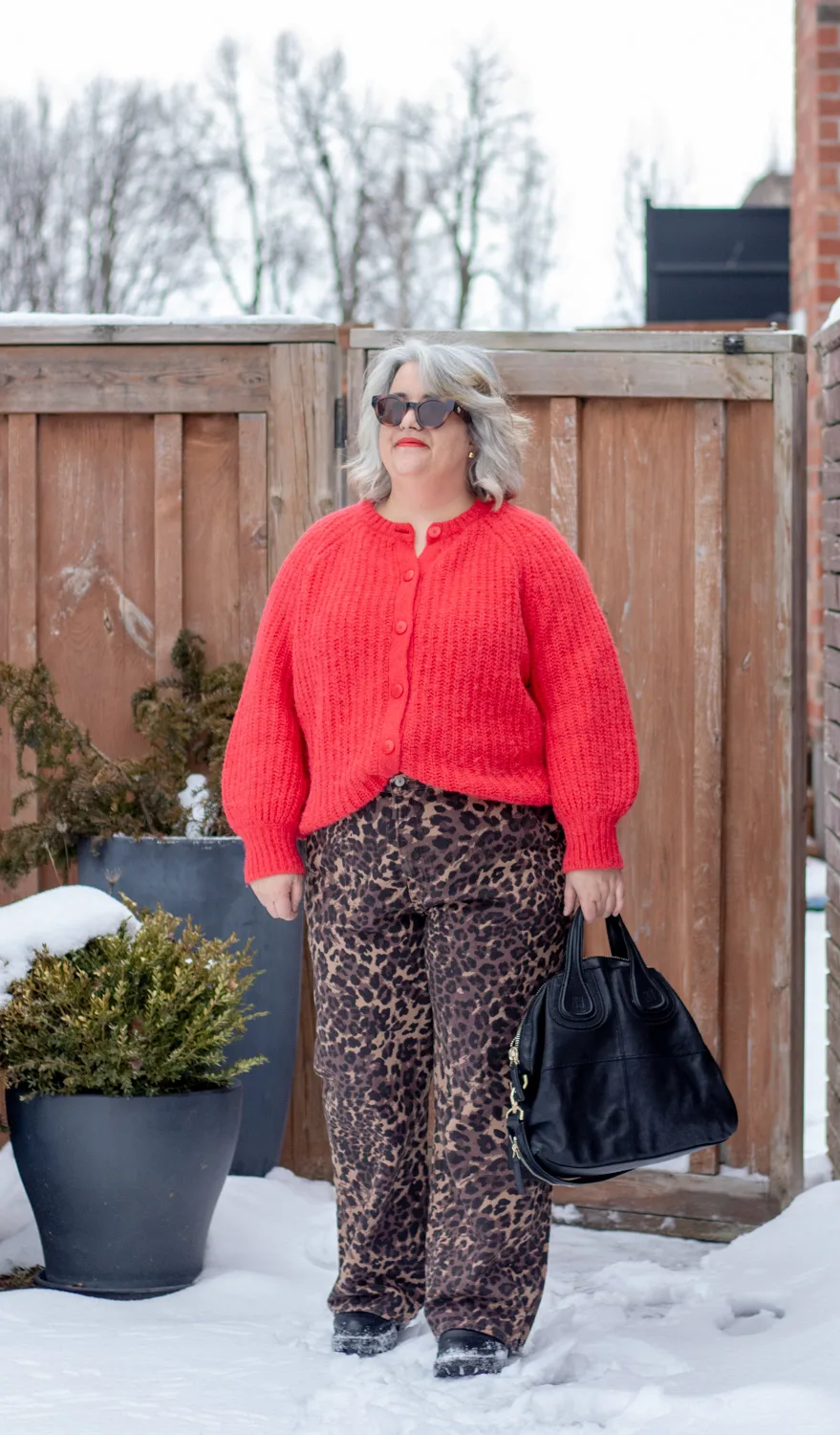 leopard jeans with a red chunky knit sweater